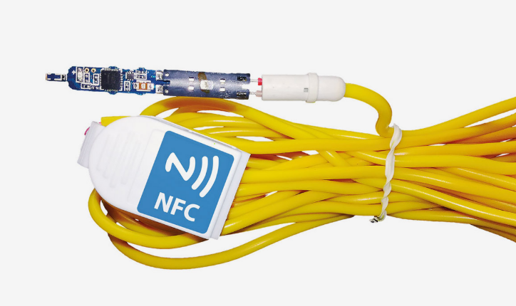 Scantronic-elektroninen nalli ja NFC-tunniste keltaisella sytytysjohdolla